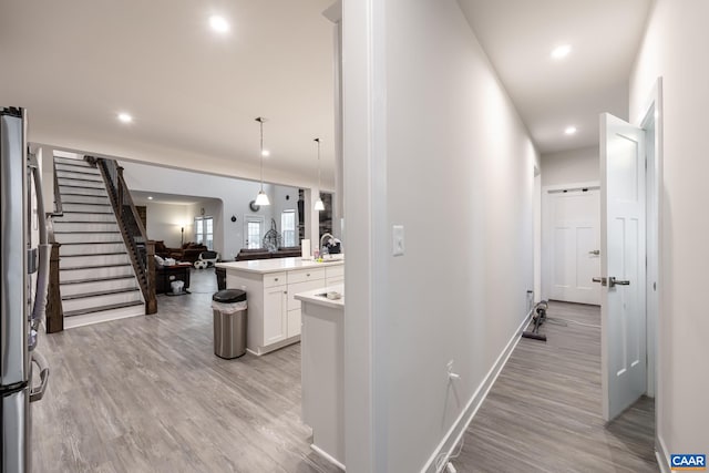 hallway featuring light wood-type flooring and sink