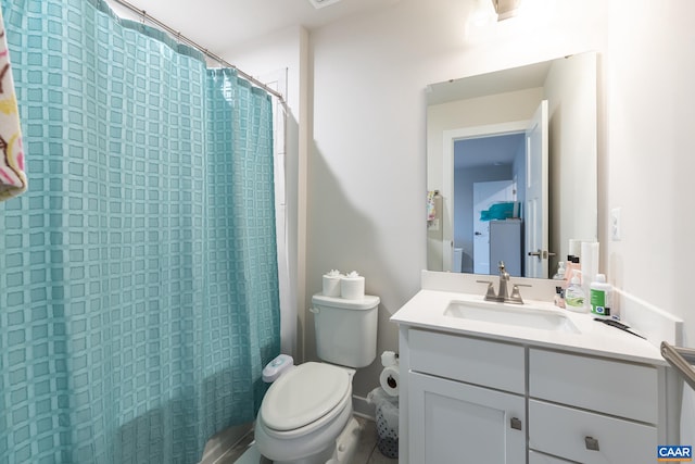 bathroom featuring curtained shower, vanity, and toilet