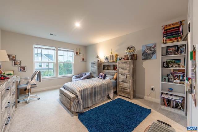 bedroom featuring light carpet, visible vents, and baseboards