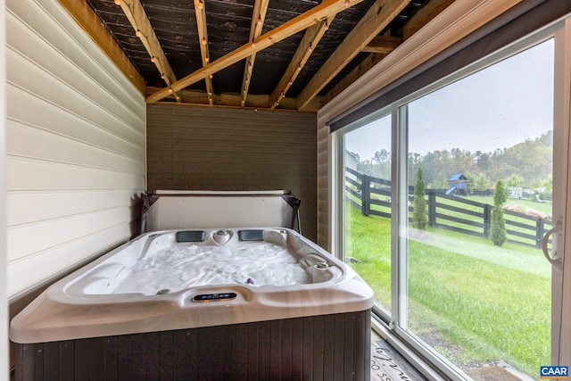 bathroom with wood walls and plenty of natural light