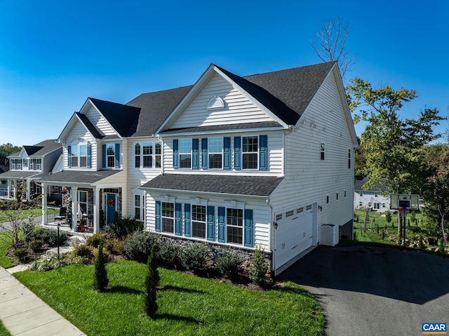 view of front of property featuring a garage and a front yard