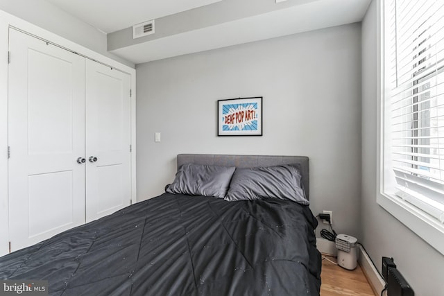 bedroom featuring a closet and dark hardwood / wood-style flooring