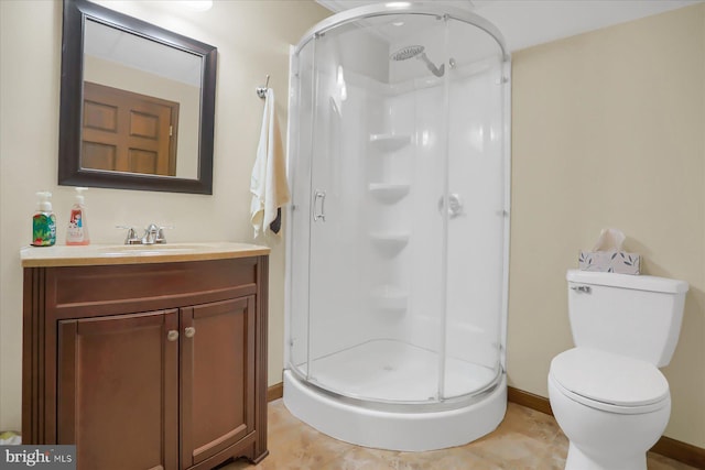 bathroom featuring vanity, tile patterned flooring, toilet, and walk in shower