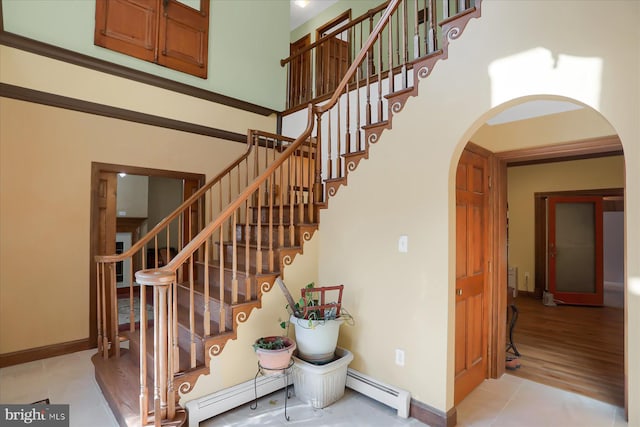 stairway featuring a baseboard radiator and hardwood / wood-style floors