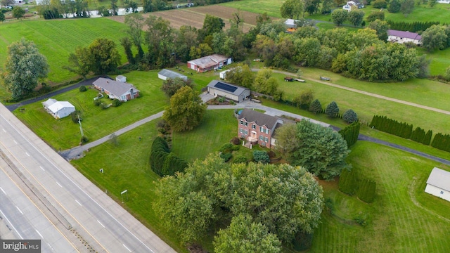 birds eye view of property with a rural view