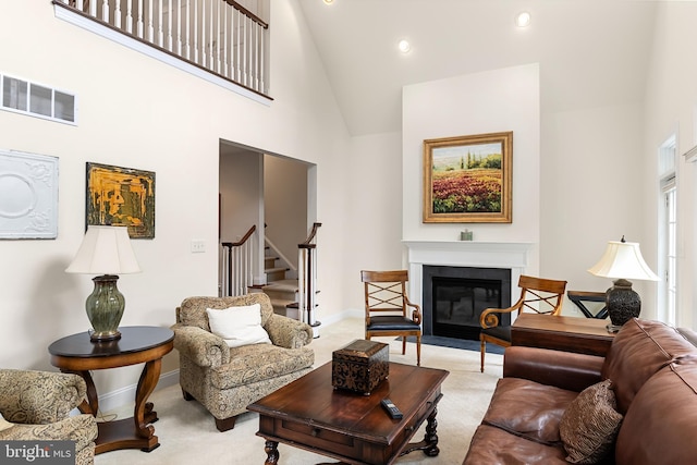 living room featuring high vaulted ceiling and light colored carpet