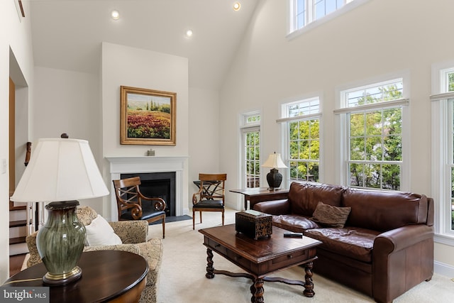 living room featuring high vaulted ceiling and light colored carpet