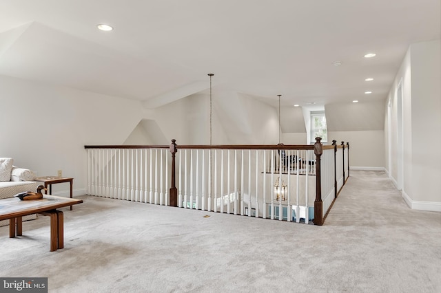 interior space with lofted ceiling and light colored carpet