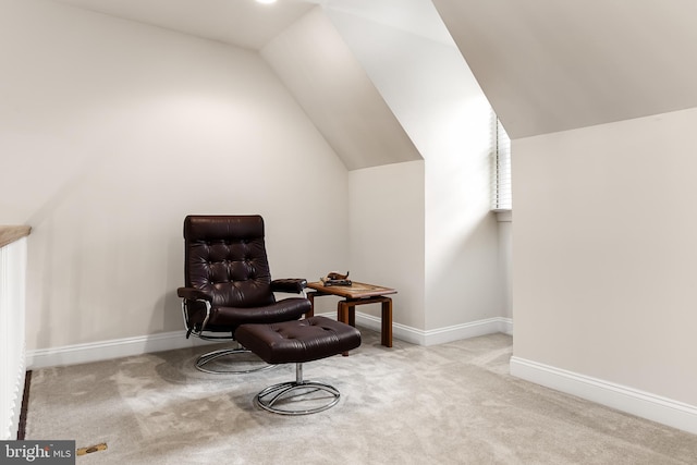 living area with lofted ceiling and light colored carpet