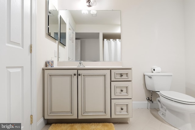 bathroom featuring tile patterned flooring, vanity, and toilet