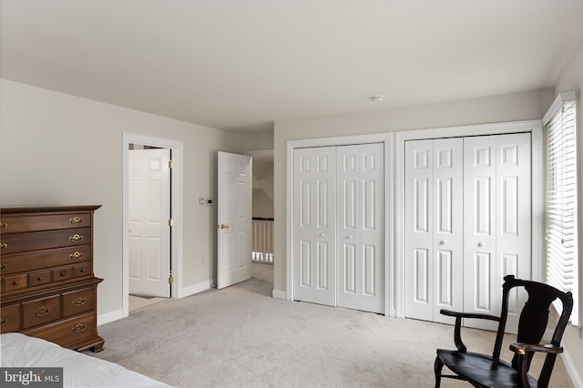 carpeted bedroom with two closets