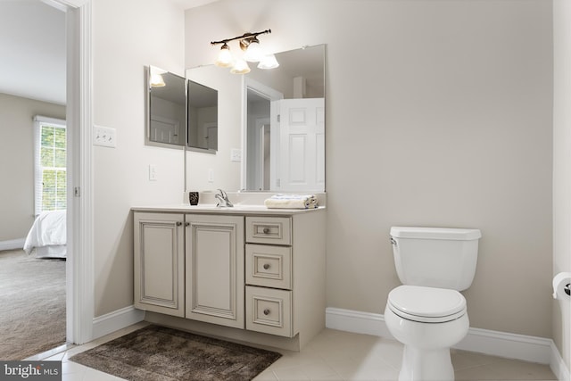 bathroom featuring tile patterned floors, vanity, and toilet