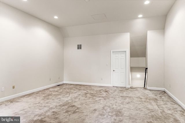 empty room with carpet flooring and vaulted ceiling