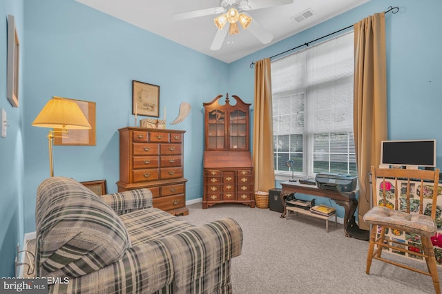 sitting room with ceiling fan and carpet flooring