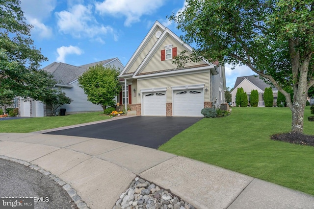 view of front of home with a front lawn and a garage