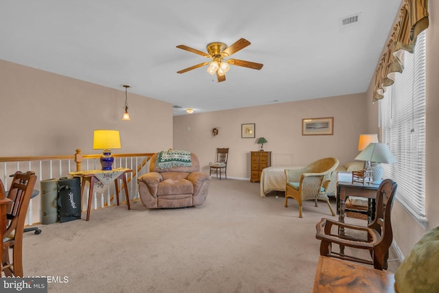 living room featuring light colored carpet and ceiling fan