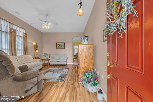 living room with hardwood / wood-style flooring, vaulted ceiling, and ceiling fan