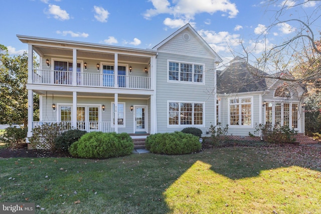 216 Chew E, Saint Michaels, MD 21663 - view of front of property with a balcony, a porch, and a front yard