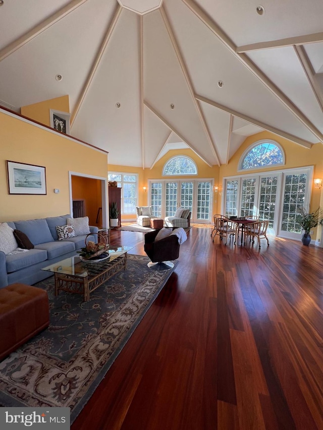 living room featuring high vaulted ceiling, hardwood / wood-style flooring, and beam ceiling