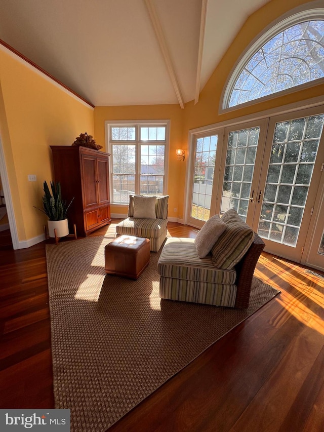 living room featuring hardwood / wood-style floors, vaulted ceiling with beams, and french doors