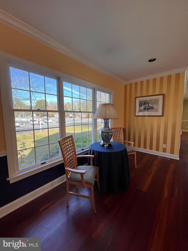 dining space featuring wood-type flooring and crown molding