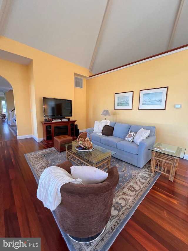 living room featuring high vaulted ceiling and dark hardwood / wood-style flooring