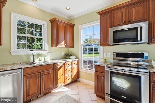 216 Chew E, Saint Michaels, MD 21663 - kitchen with appliances with stainless steel finishes, a sink, light stone counters, light tile patterned floors, and ornamental molding