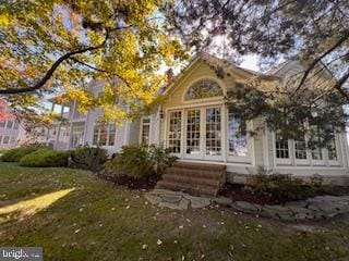 back of property featuring a lawn