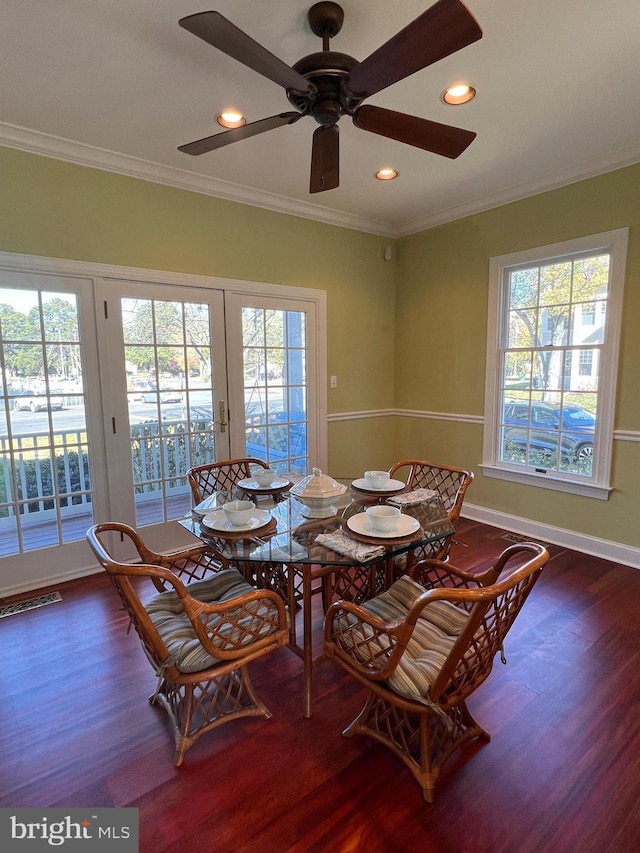 unfurnished dining area featuring ornamental molding, a wealth of natural light, dark hardwood / wood-style floors, and ceiling fan