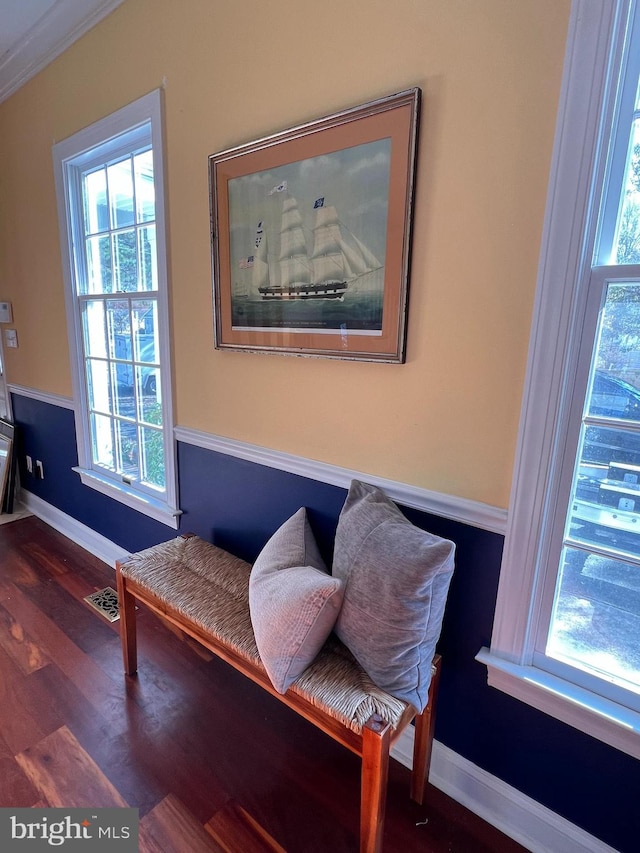 sitting room with dark hardwood / wood-style floors and crown molding