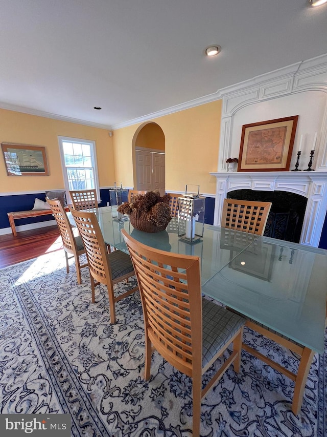 dining room featuring hardwood / wood-style floors and ornamental molding