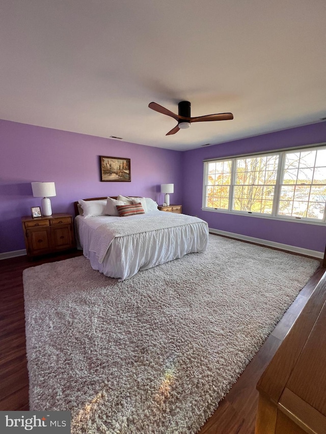 bedroom with dark wood-type flooring and ceiling fan