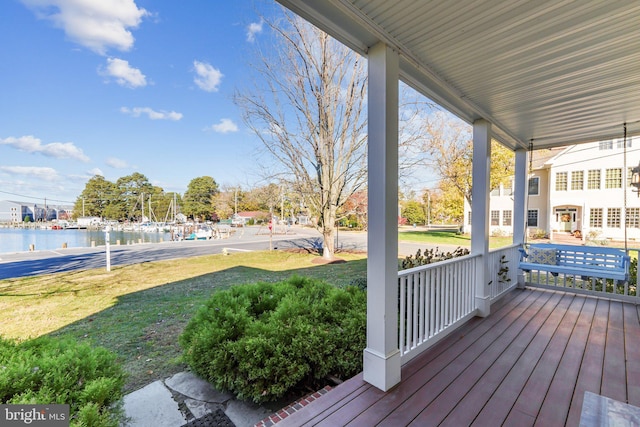 216 Chew E, Saint Michaels, MD 21663 - wooden terrace featuring covered porch, a water view, and a lawn