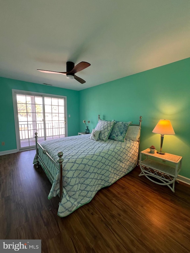 bedroom featuring access to outside, dark hardwood / wood-style flooring, and ceiling fan