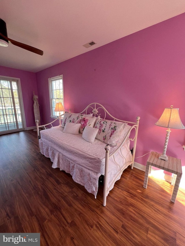 bedroom featuring dark wood-type flooring, ceiling fan, and access to exterior