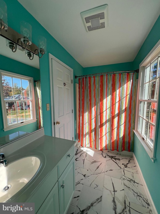 bathroom featuring vanity and a healthy amount of sunlight