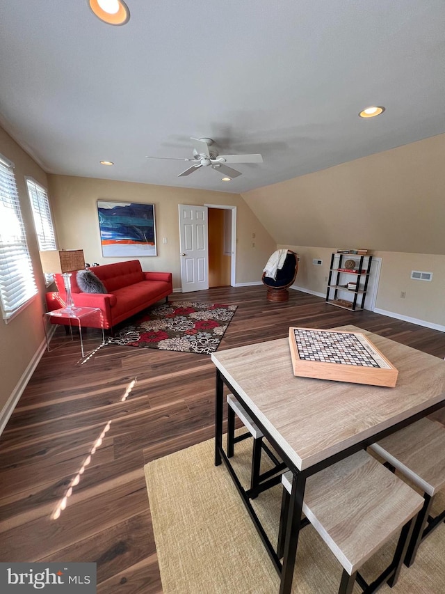 living room with dark wood-type flooring, lofted ceiling, and ceiling fan