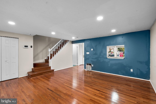 interior space with wood-type flooring and a textured ceiling