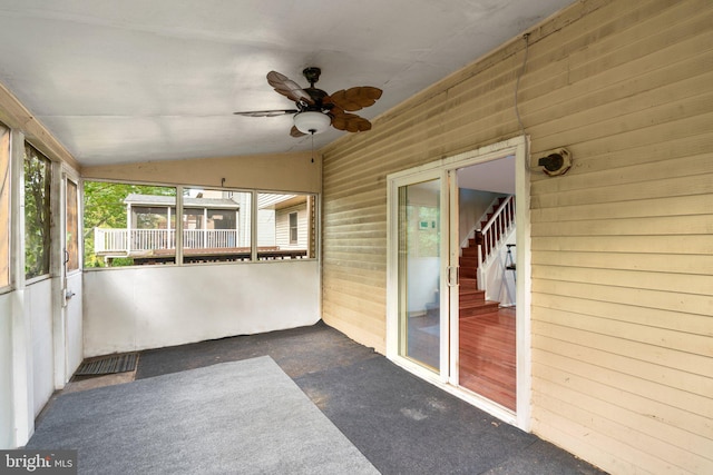 unfurnished sunroom featuring vaulted ceiling and ceiling fan