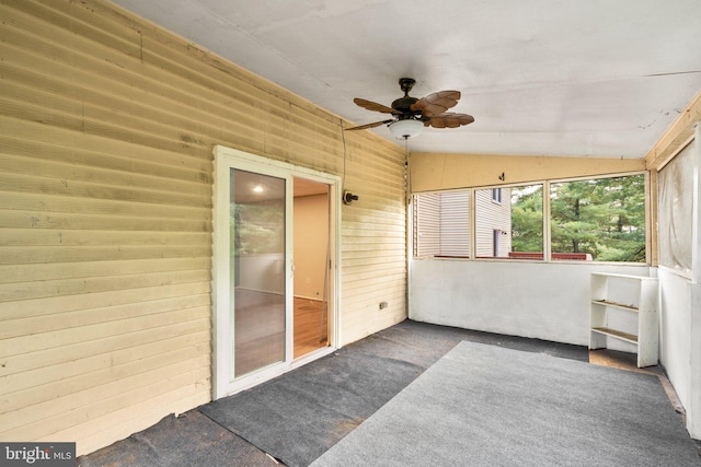 sunroom with ceiling fan and vaulted ceiling