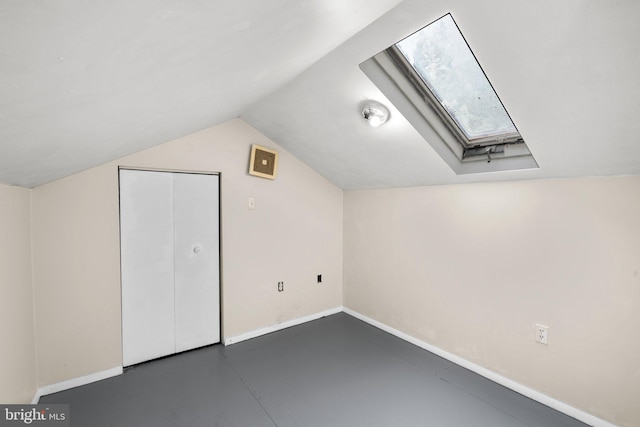 bonus room with vaulted ceiling with skylight