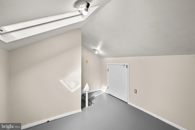 bonus room featuring concrete floors and vaulted ceiling