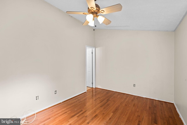 unfurnished room with ceiling fan, vaulted ceiling, and hardwood / wood-style floors