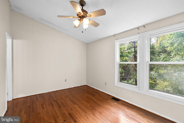 spare room with hardwood / wood-style flooring, plenty of natural light, and ceiling fan