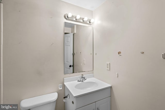 bathroom featuring toilet and vanity