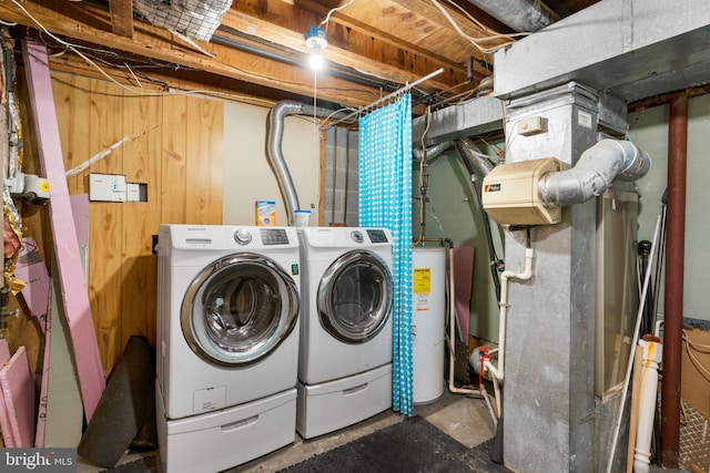 laundry area featuring independent washer and dryer, water heater, and heating unit