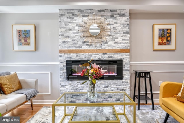 living room with a fireplace and hardwood / wood-style flooring