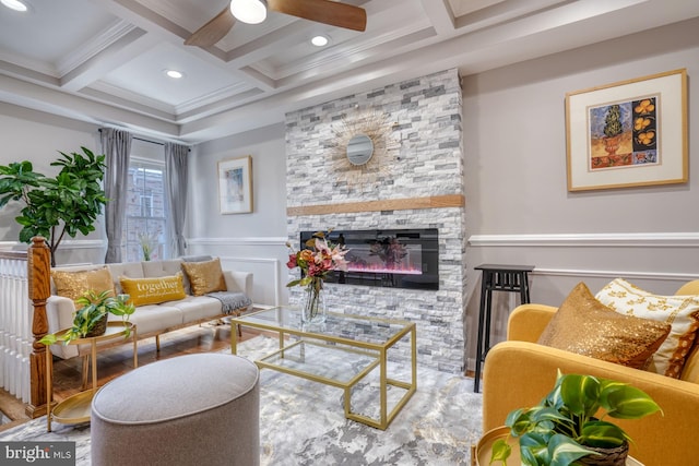 living room with coffered ceiling, ornamental molding, beamed ceiling, and a fireplace