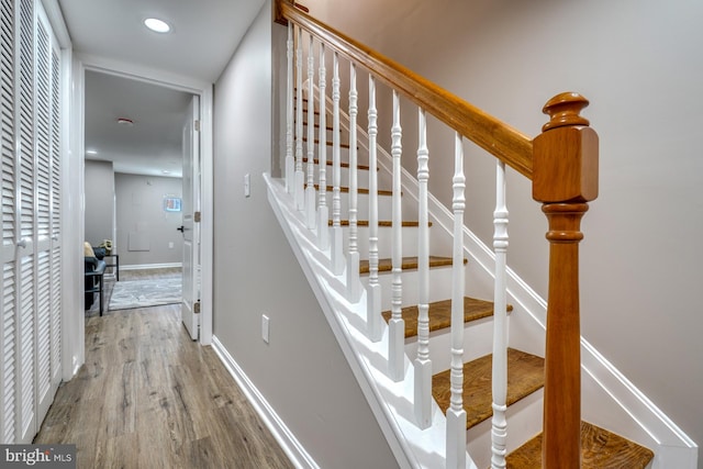 stairway with hardwood / wood-style flooring