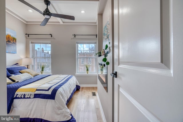 bedroom featuring crown molding, light hardwood / wood-style floors, and ceiling fan